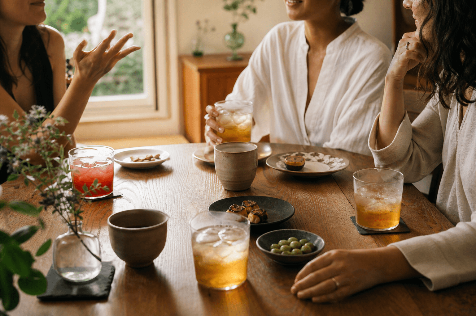 Friends sharing homemade tea drinks around a dining table